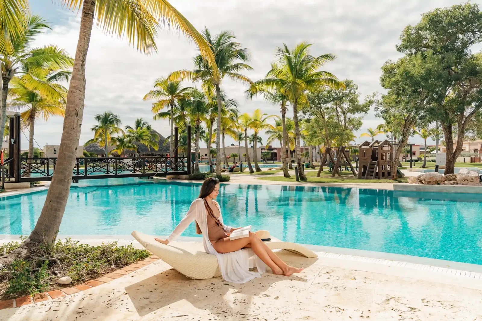 Poolside relaxation beneath the palms at TAN Resorts Marina Cap Cana